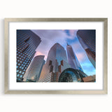 Extra large abstract art print of Manhattan skyline in textured grays and blues, framed in silver.