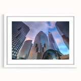 Textured abstract art print of Manhattan skyline in muted gray and blue tones, framed with a white mat.