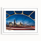 Abstract art print of Nashville skyline in muted gray and blue tones on a framed white mat, ideal for dining room decor.