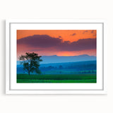 Abstract art print of Vermont scenery in muted green and blue tones on a framed white mat, ideal for dining room decor.