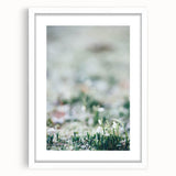 Abstract art print depicting spring with soft green and yellow tones on a white framed canvas.