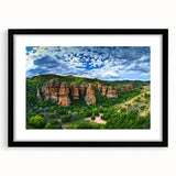 Black-framed landscape art print showcasing a dramatic cliff scene, elegantly matted for display, perfect for enhancing home decor with a modern touch.