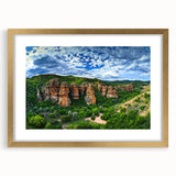 Elegant gold-framed landscape artwork depicting dramatic cliffs, showcasing intricate details and a sophisticated matting, perfect for enhancing home decor.