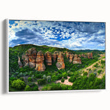 Framed canvas artwork depicting a breathtaking landscape of cliffs, showcasing vibrant colors and intricate details, presented in a white frame for a modern aesthetic.