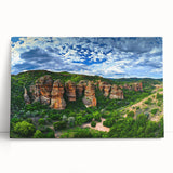 Stretched canvas artwork depicting dramatic cliffs at sunset, showcasing vibrant oranges and purples. Ideal for modern home decor or nature-themed interiors.