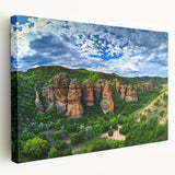 Stretched canvas artwork depicting dramatic landscapes with cliffs, showcasing vibrant colors and intricate details, perfect for enhancing home decor.
