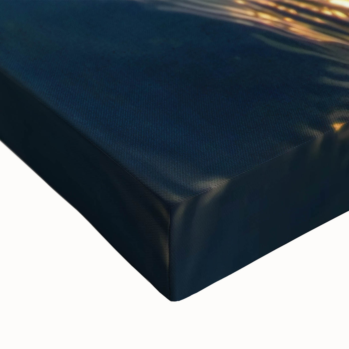 Close-up of a stretched canvas artwork depicting a serene beach landscape with soft waves and vibrant sunset colors, ideal for coastal home decor.