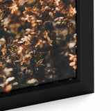 Close-up of a textured, extra large framed canvas depicting colorful fall foliage in black tones.