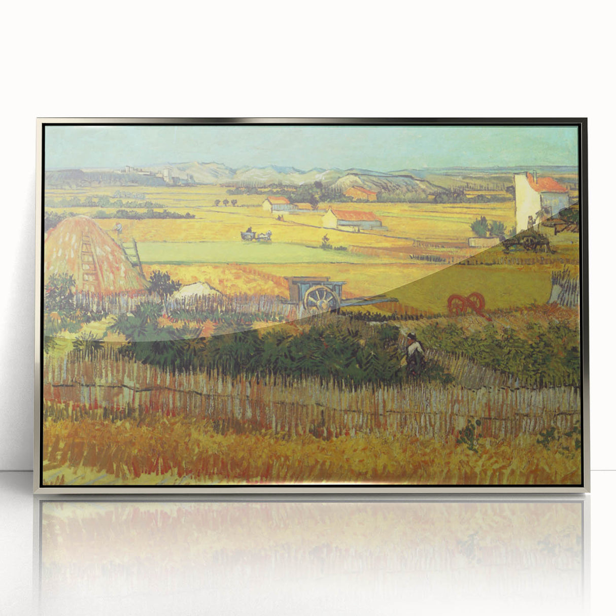 Large art print of Van Gogh's Starry Night in muted blues and yellows, framed in silver acrylic.