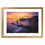 Framed landscape artwork depicting towering cliffs with a gold mat, showcasing natural scenery in an elegant frame, perfect for home decor.