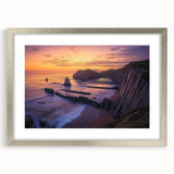 Silver-framed landscape artwork depicting dramatic cliffs, elegantly matted, perfect for home decor or art enthusiasts seeking modern elegance.