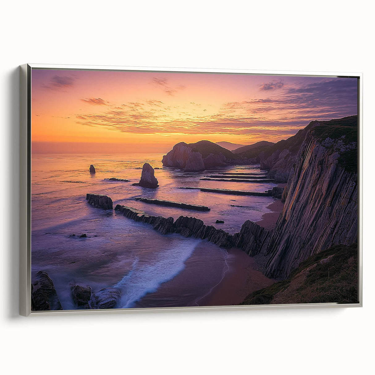 Framed canvas artwork showcasing a breathtaking landscape of dramatic cliffs in soft hues, with a sleek silver frame, ideal for modern home decor.