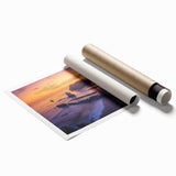 Stunning landscape print showcasing rocky cliffs under a vibrant sunset, rolled and ready for display, ideal for home decor or art enthusiasts.