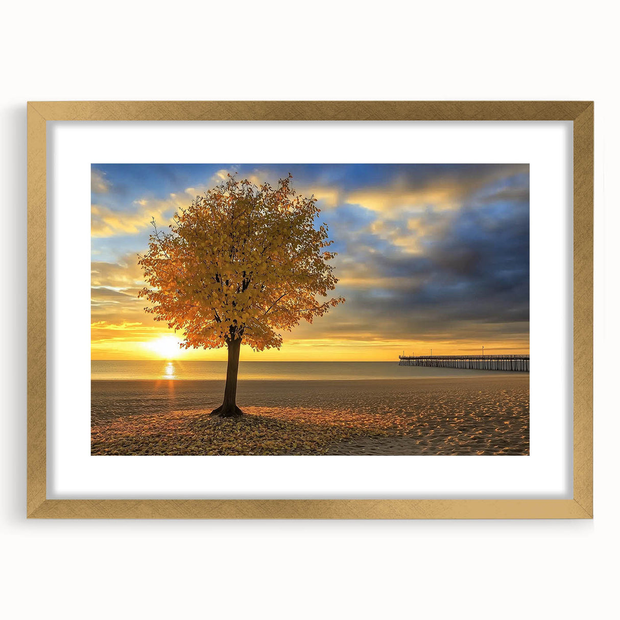 Framed landscape artwork displaying a serene beach scene with soft waves and golden sand, accented by a sophisticated gold mat, ideal for home decor.