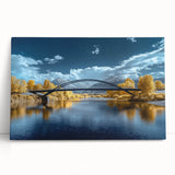 Stretched canvas artwork depicting a scenic landscape bridge over a serene body of water, featuring lush greenery and a vibrant sky, perfect for home decor.
