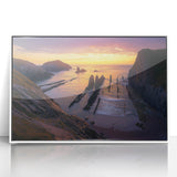 Framed acrylic artwork depicting a stunning cliffside landscape with vibrant colors and intricate details, set against a sleek white frame for modern decor.