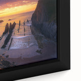 Close-up of a framed canvas featuring a dramatic landscape of rugged cliffs and serene ocean waves, showcasing intricate textures and vibrant colors that enhance any interior decor.