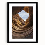 Black-framed landscape art featuring stunning canyons, with a white mat enhancing its depth, perfect for home decor and nature enthusiasts. Ideal for adding character to any space.