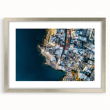 Framed artwork of a dramatic cliff landscape in silver matting, showcasing vibrant colors and intricate details, perfect for home or office decor enhancement.