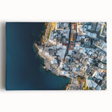 Stretched canvas artwork depicting dramatic coastal cliffs under a vibrant sunset, showcasing rich colors and intricate textures, ideal for modern home decor.