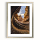 Framed landscape artwork showcasing vibrant canyons in earthy tones, elegantly displayed with a silver mat for a modern touch, perfect for home decor.