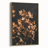 Framed canvas depicting a vintage-style landscape painting with autumnal trees in gold and black tones.