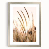 Textured art print featuring abstract swirls in muted gray and silver tones, framed in silver, ideal for bedroom art.