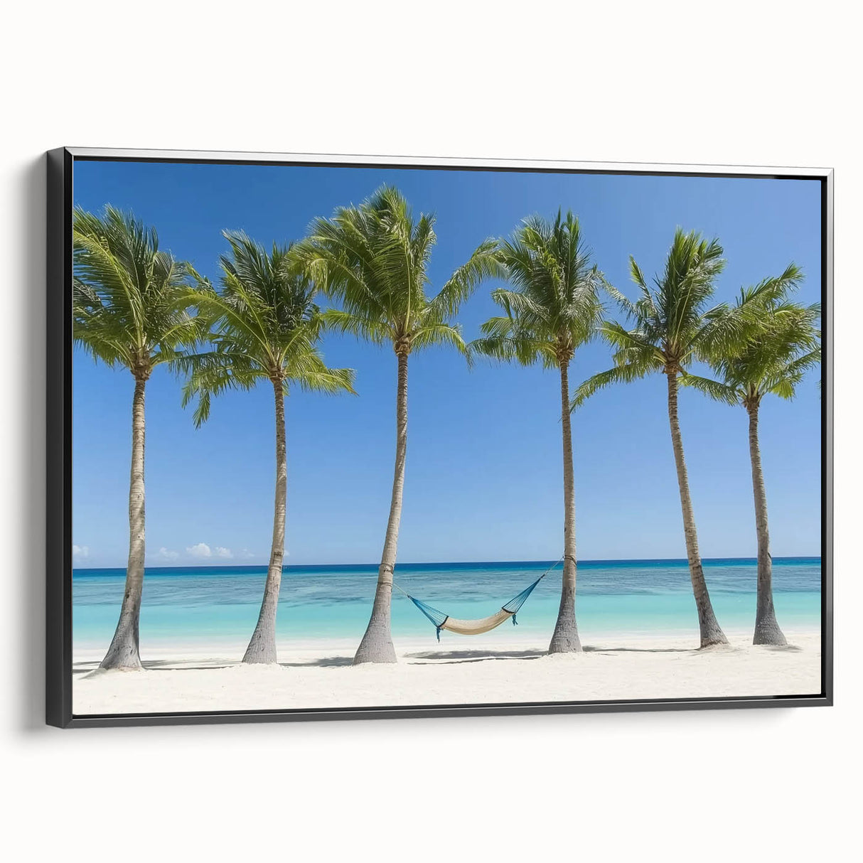 Framed landscape canvas art depicting serene beach scenery with vivid blue sky and golden sand, featuring a sleek black frame for elegant presentation.