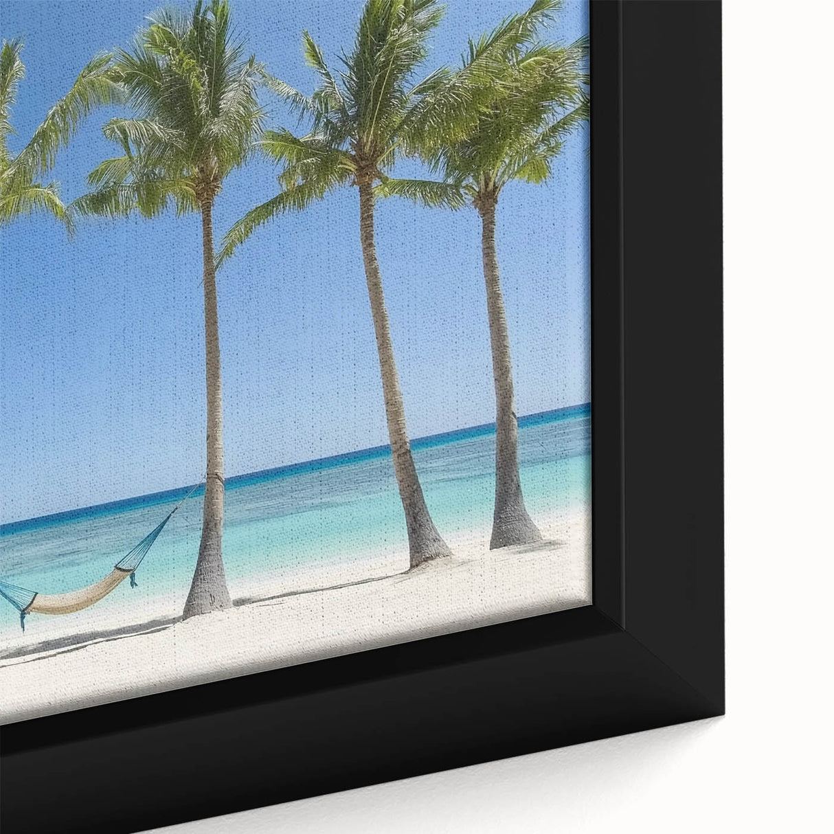 Close-up of a vibrant framed canvas artwork depicting a serene beach landscape with soft waves and a colorful sunset sky, perfect for coastal home decor.
