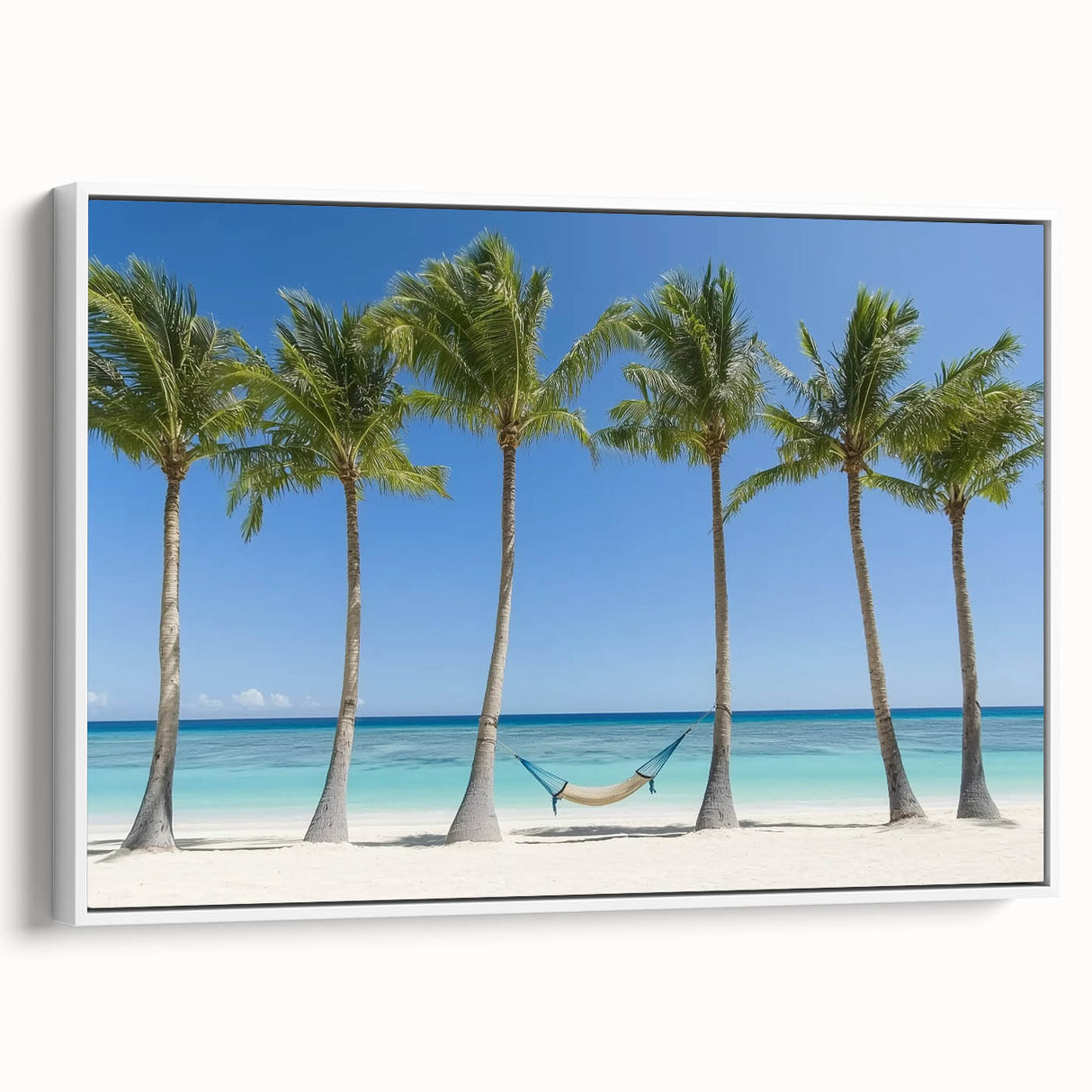 Framed canvas artwork depicting a serene beach landscape with vibrant blue skies and soft white sands, showcasing a modern, minimalist white frame for elegant decor. Perfect for coastal-themed interiors.
