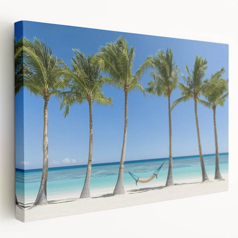 Landscape canvas artwork showcasing a serene beach scene with soft waves and a sunset sky, featuring vibrant colors and a side view that highlights its stretched design. Perfect for coastal home decor or beach-themed interiors.