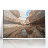 Framed acrylic wall art depicting a vibrant landscape of canyons in warm earth tones, showcasing intricate details and a modern white frame, perfect for home decor.