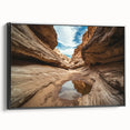 Framed canvas artwork depicting a stunning landscape of canyons, showcasing vibrant colors and intricate details, displayed with a sleek black frame for an elegant touch.