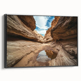 Framed canvas artwork depicting a stunning landscape of canyons, showcasing vibrant colors and intricate details, displayed with a sleek black frame for an elegant touch.