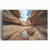 Stretched canvas artwork depicting vibrant landscape canyons under a clear blue sky, showcasing rich colors and intricate textures, perfect for home decor.
