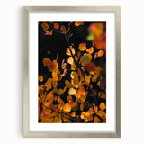 Textured abstract art print in orange and brown tones on a silver-framed canvas, ideal for bedroom decor.