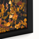 Framed canvas featuring a textured, colorful abstract design in black with vibrant autumn hues, ideal for living room decor.