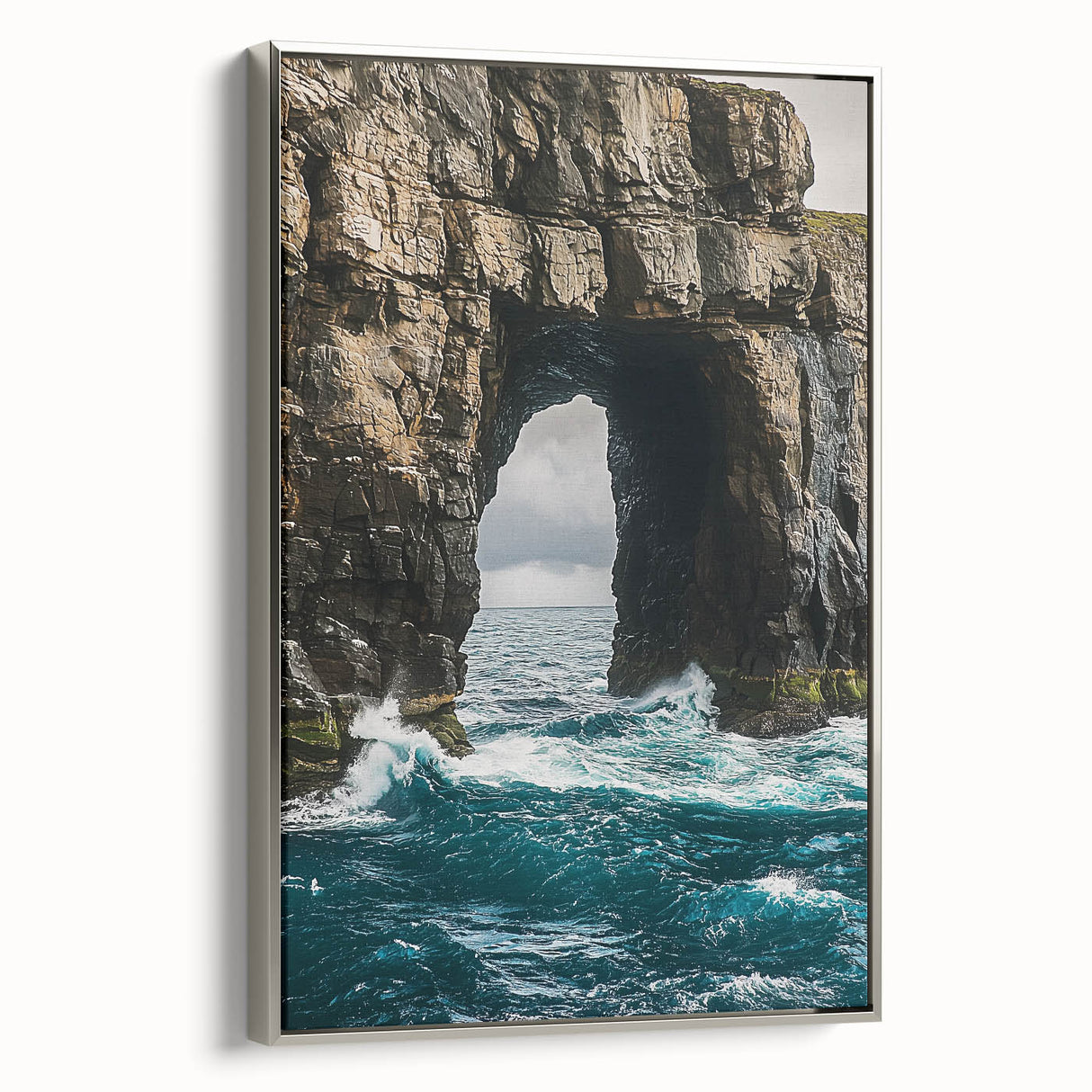 Framed canvas artwork showcasing a breathtaking view of rugged cliffs against a vibrant sky, featuring a sleek silver frame that enhances the landscape's beauty. Perfect for home decor.