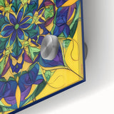 Close-up view of an abstract geometric design on acrylic glass, featuring vibrant blue, yellow, and white colors. Ideal for modern home decor and artistic displays.