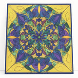 Abstract geometric stretched canvas art piece featuring vibrant colors and intricate shapes, perfect for modern decor. The artwork leans against a neutral background, showcasing its contemporary design and texture. Ideal for adding a pop of color to living spaces or offices.