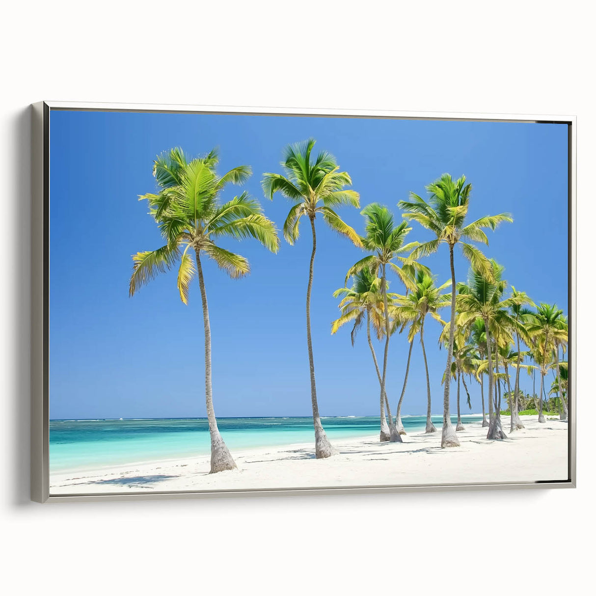 Framed canvas artwork depicting a serene beach landscape with vibrant colors, featuring a silver frame and side view that highlights its stylish design.