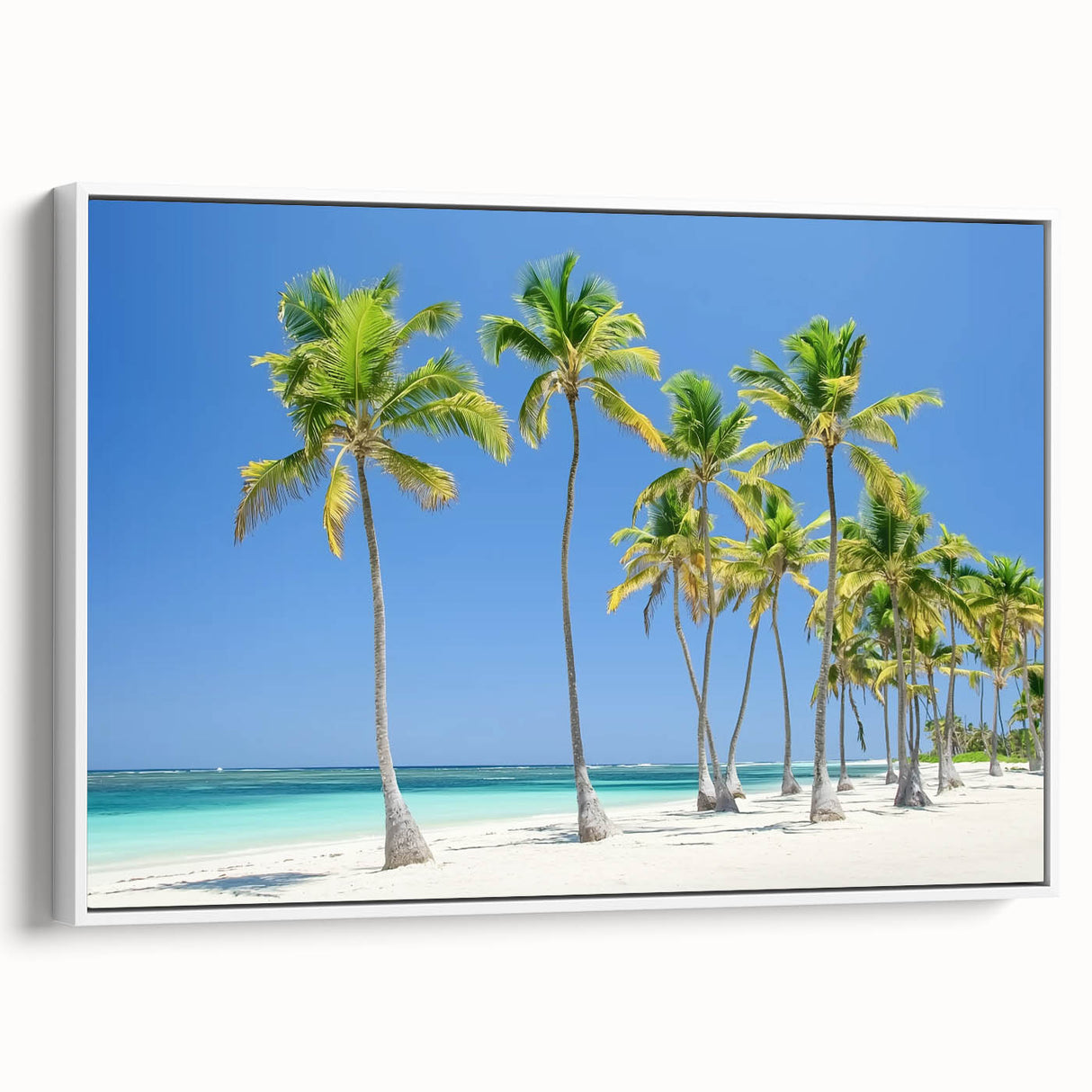 Framed canvas artwork showcasing a serene beach landscape with vibrant colors, displayed in a sleek white frame, ideal for home decor enhancement.