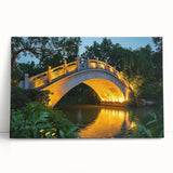 Landscape canvas print showcasing a serene bridge over a tranquil river, surrounded by lush greenery and vibrant foliage, perfect for nature lovers and home decor. This artwork brings a calming, natural ambiance to any space.