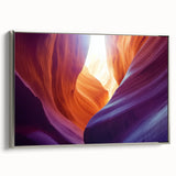 Framed landscape canvas print showcasing stunning canyons in vibrant colors, displayed with a sleek silver frame, perfect for modern home decor. This artwork adds depth and natural beauty to any living space.