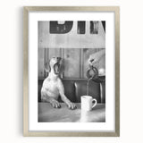 Textured abstract art print depicting animated food characters in muted earth tones, framed in silver.