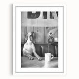 Abstract art print featuring silhouetted figures in a café, in muted earth tones, framed with a white mat.