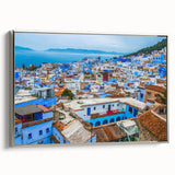 Vintage poster art of a Moroccan landscape on framed canvas, featuring a black and colorful palette.