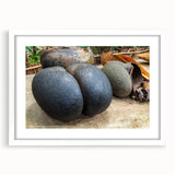 Abstract art print of Seychelles scenery in muted blue and green tones, framed with a white mat.