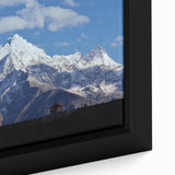 Framed canvas featuring a vintage-style landscape painting of the Nepalese mountains in muted earth tones.