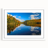 Abstract art print depicting a serene Quebec landscape in muted blue and green tones, framed with a white mat.